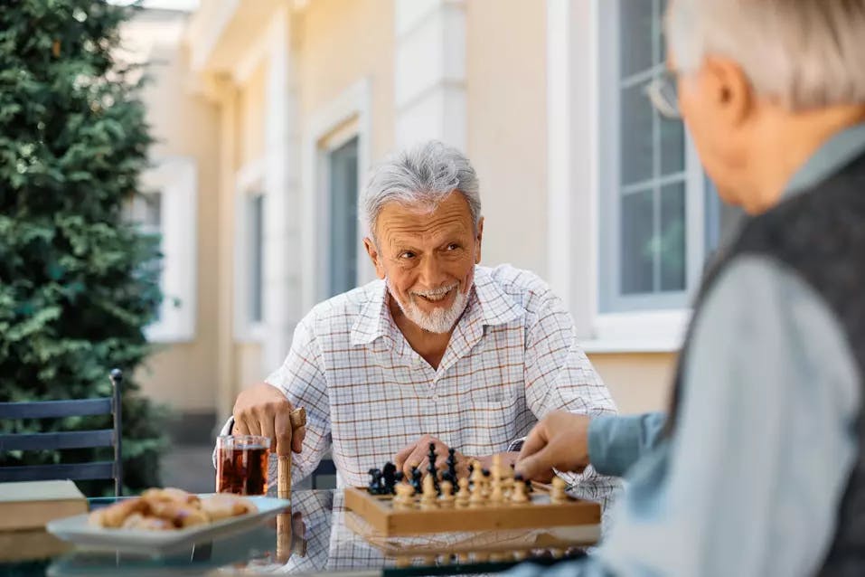 senior-men-playing-chess-on-patio