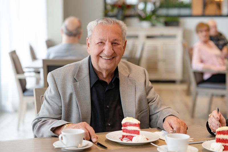 Chartwell Senior resident enjoying piece of cake and coffee