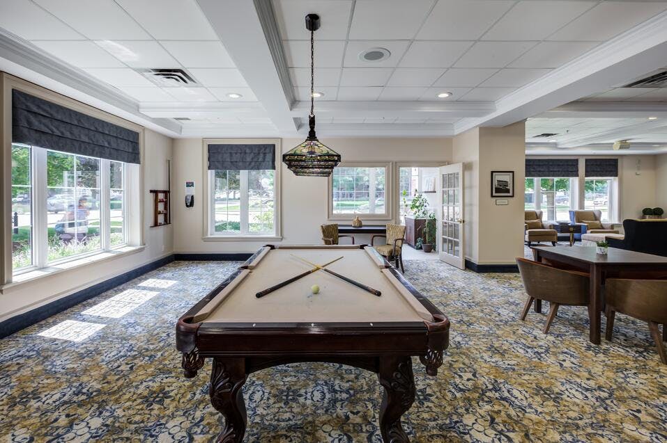 Bright and open billiards room at Chartwell Queen's Square Retirement Residence
