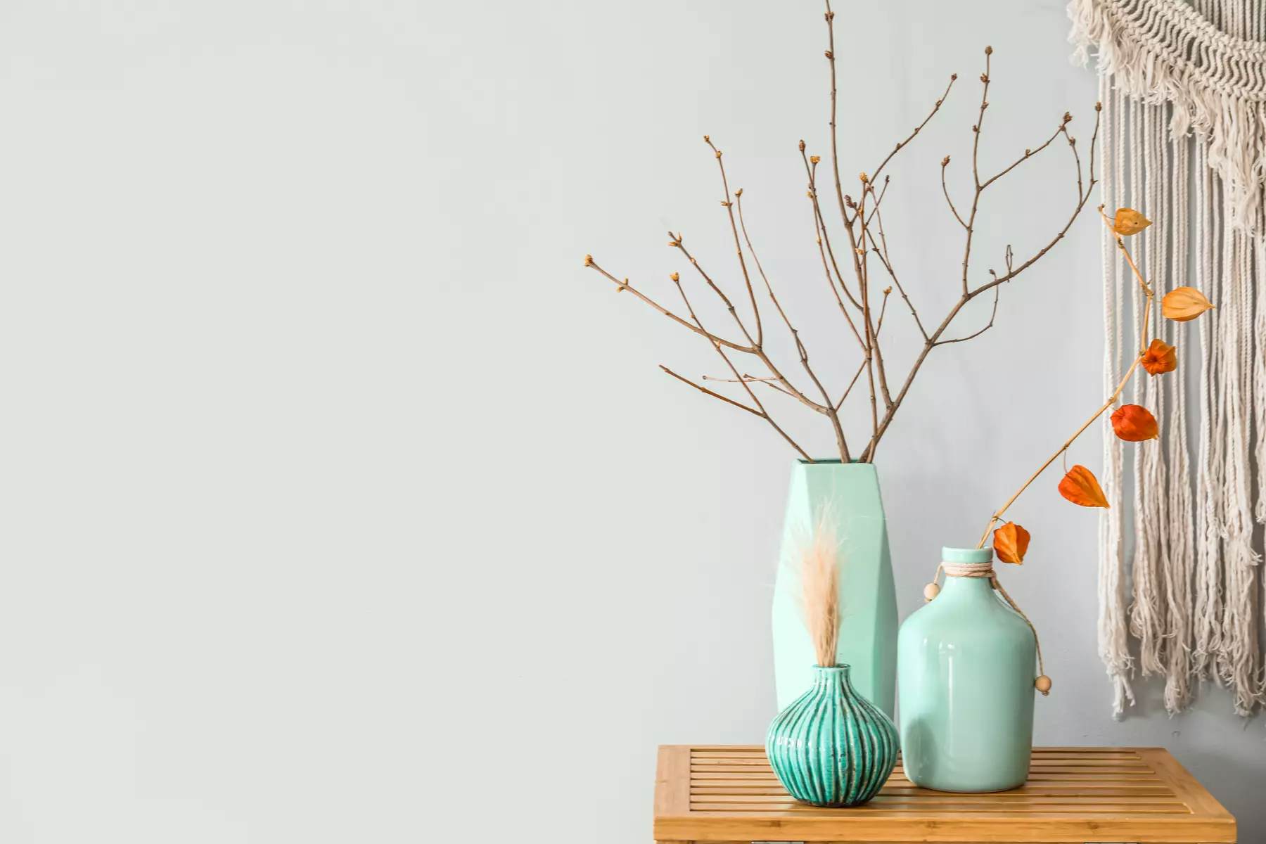 3 teal vases on top of a table