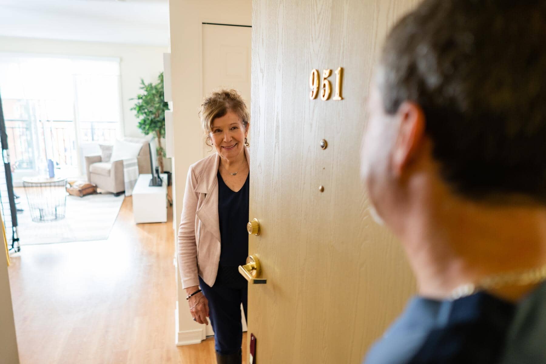 Chartwell resident opening door and welcoming guest in her room