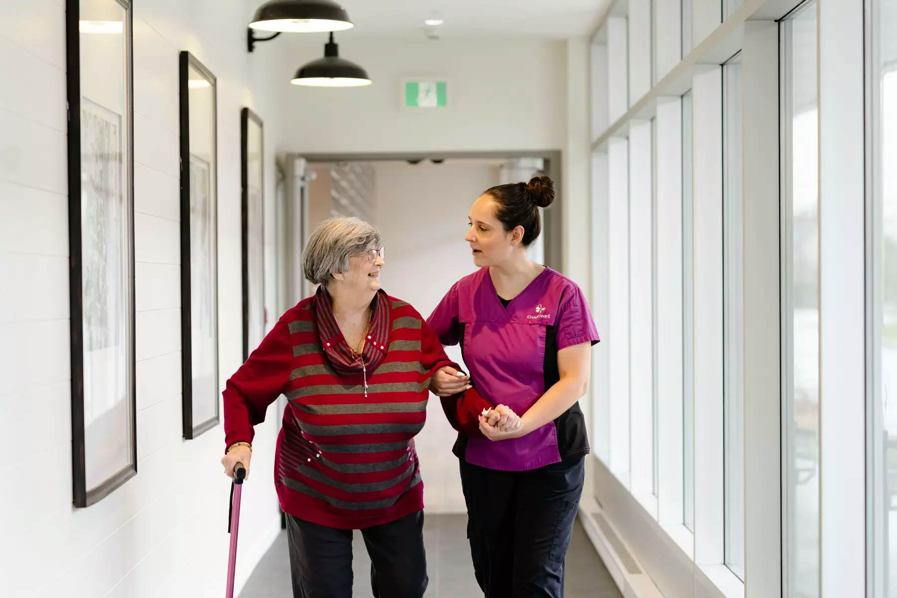 Chartwell Care staff helping Chartwell senior resident walking