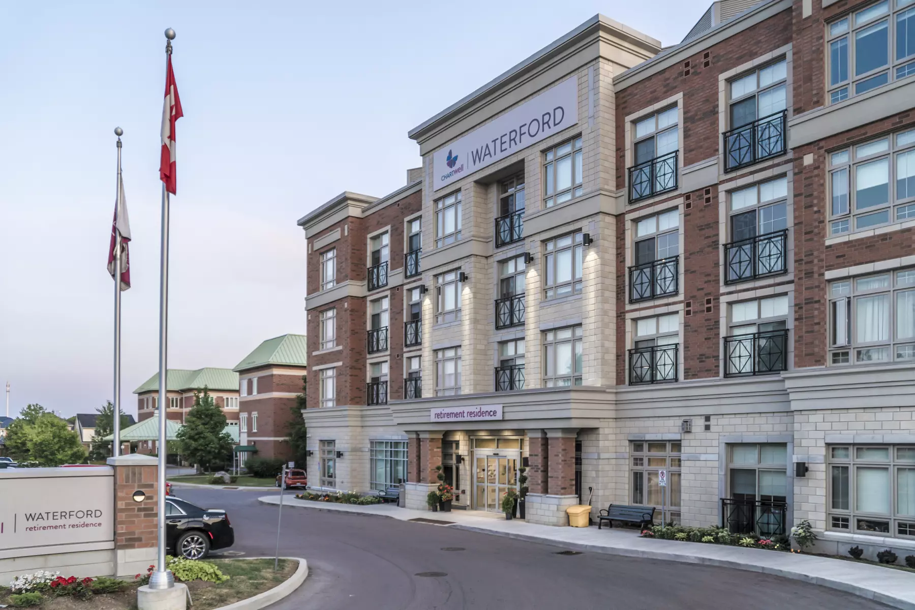 Building with Canadian flags at Chartwell Waterford Retirement Residence