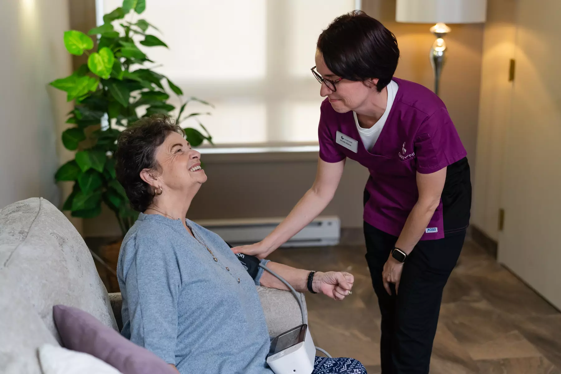 Chartwell nurse checking blood pressure of a senior resident.