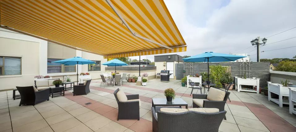 Chartwell Avondale Retirement Residence third floor patio with patio furniture, awning and bbq. 