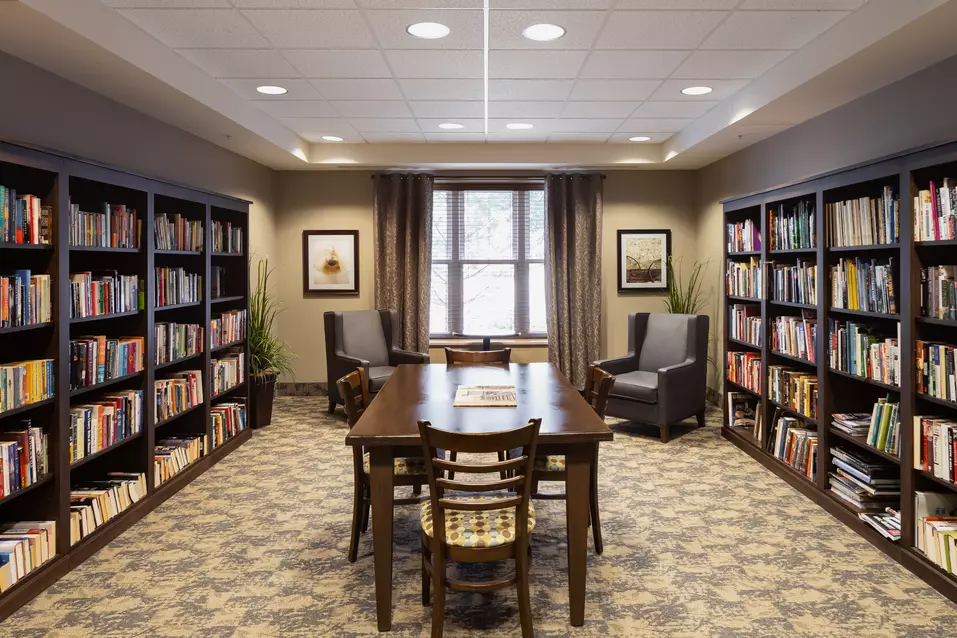 Library and puzzle table at Chartwell Balmoral Retirement Community.