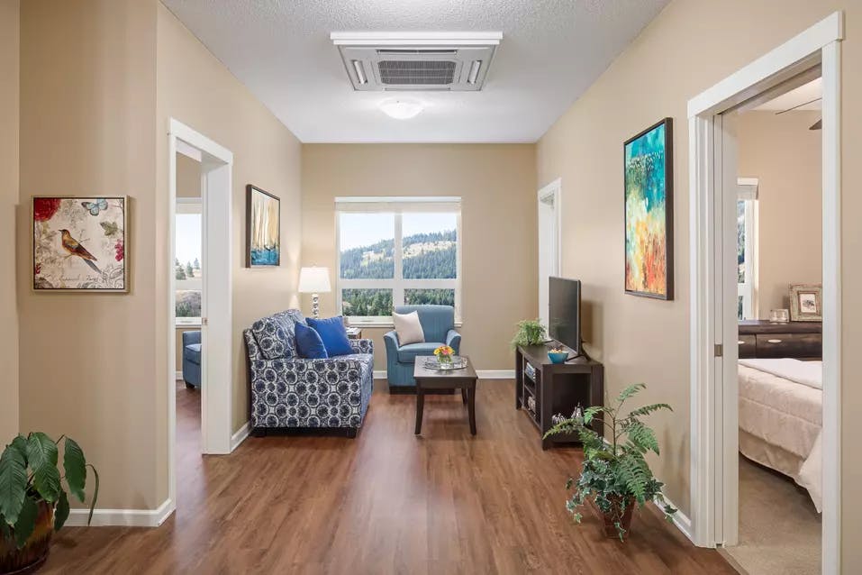 bright and sunny living room with mountain views at chartwell ridgepointe retirement residence