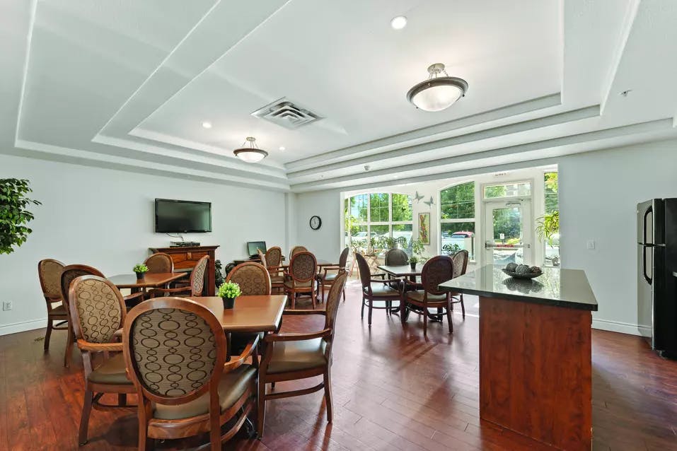 Chartwell Regency Retirement Residence   bistro with tv and seating