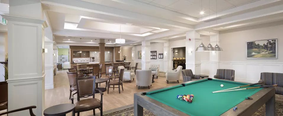 Billiards room and seating at Chartwell Waterford Retirement Residence