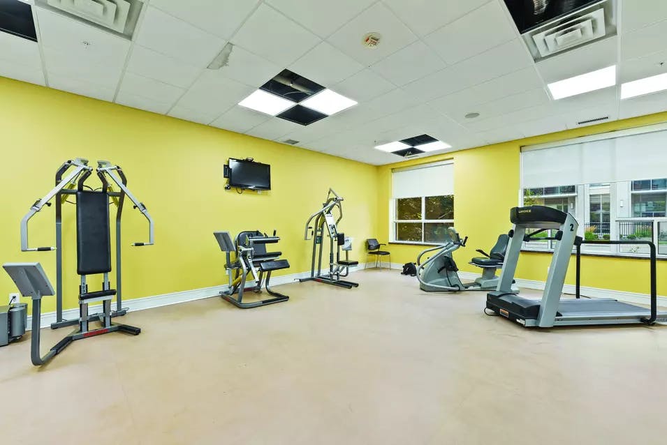 Fitness room with treadmill at Chartwell Hollandview Trail Retirement Residence.