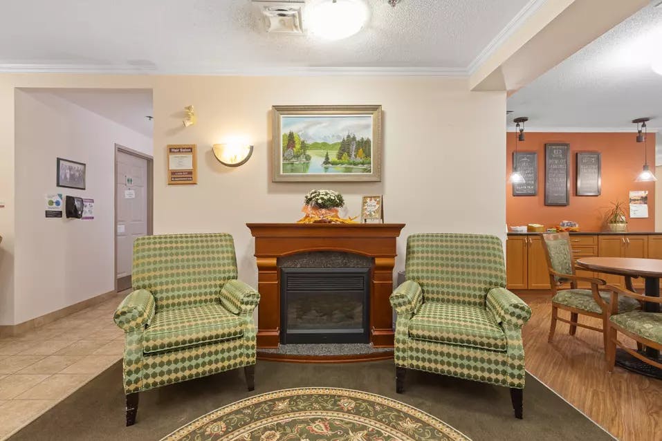 lounge with fireplace at chartwell van horne retirement residence