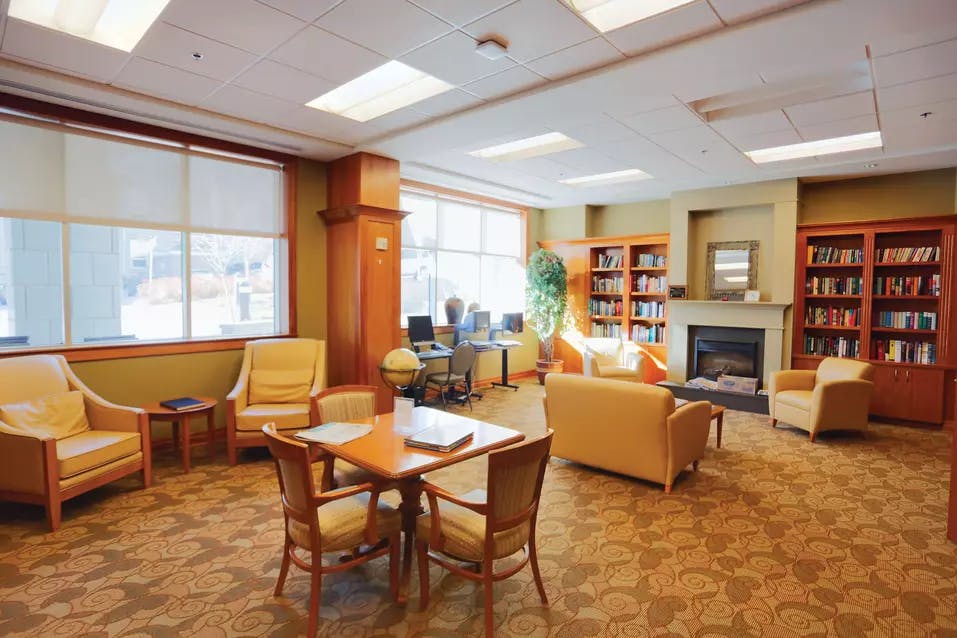 library with fireplace at chartwell wedgewood retirement residence