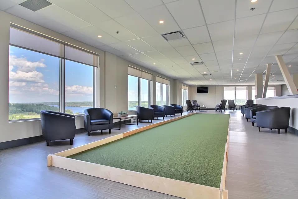 Salon commun avec télévision et jardin intérieur chez Chartwell Shawinigan / Common sitting area with television and indoor green at Chartwell Shawinigan