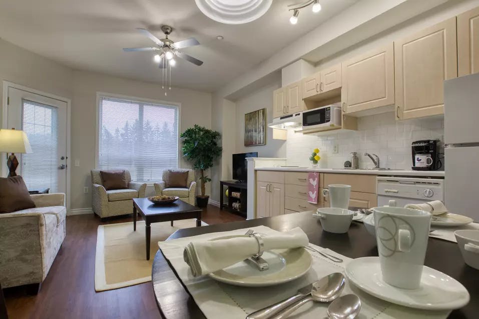beautiful kitchen and living room at chartwell colonel belcher retirement residence 