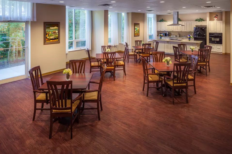 Bright and open demonstration kitchen with seating at Chartwell Valley Vista Retirement Residence 