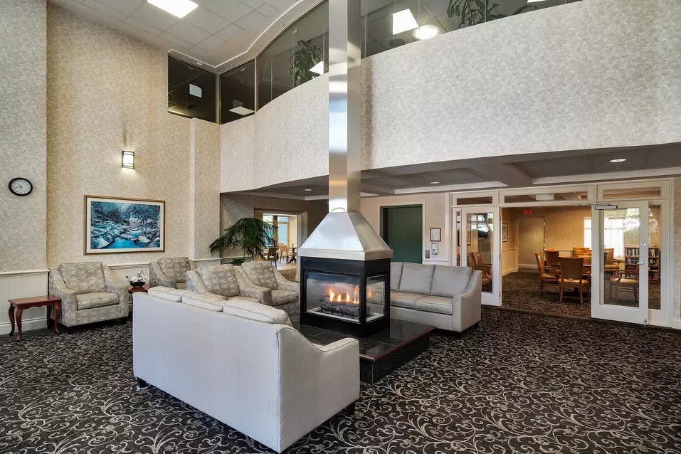 inviting and warm fireside lounge at chartwell crescent gardens retirement residence