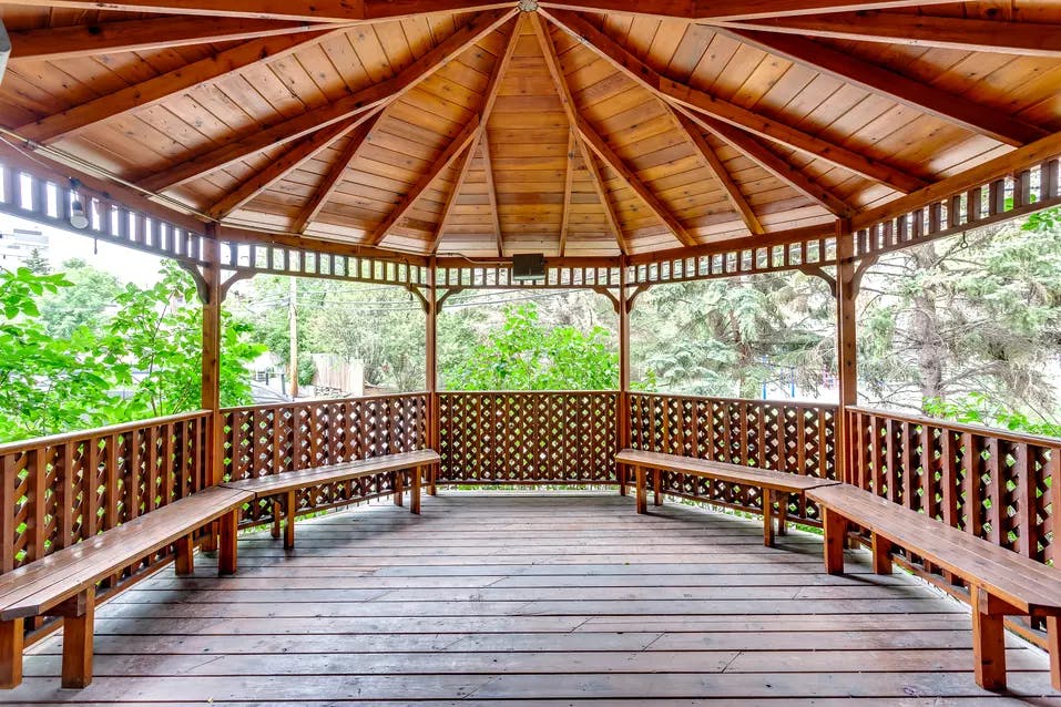 solid wood gazebo with bench seating at chartwell fountains of mission retirement residence