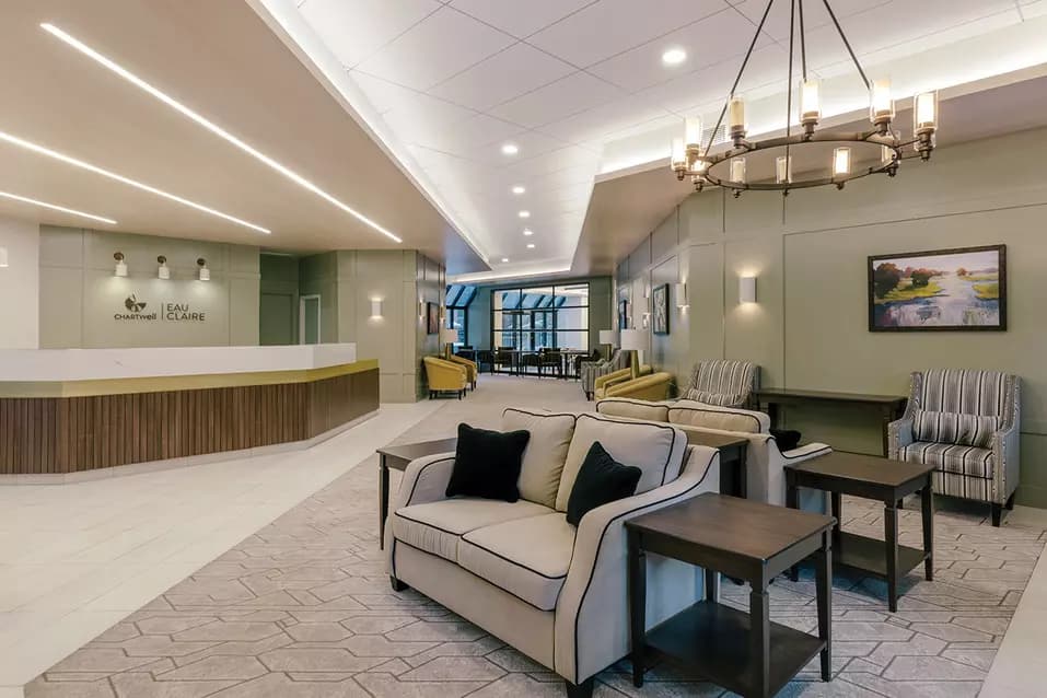 inviting and open common area and reception desk at chartwell eau claire care residence