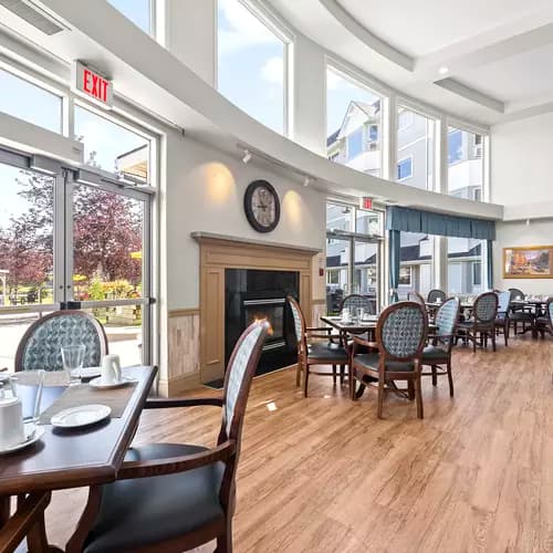 Chartwell Harbours's dining room with a large fireplace and large windows