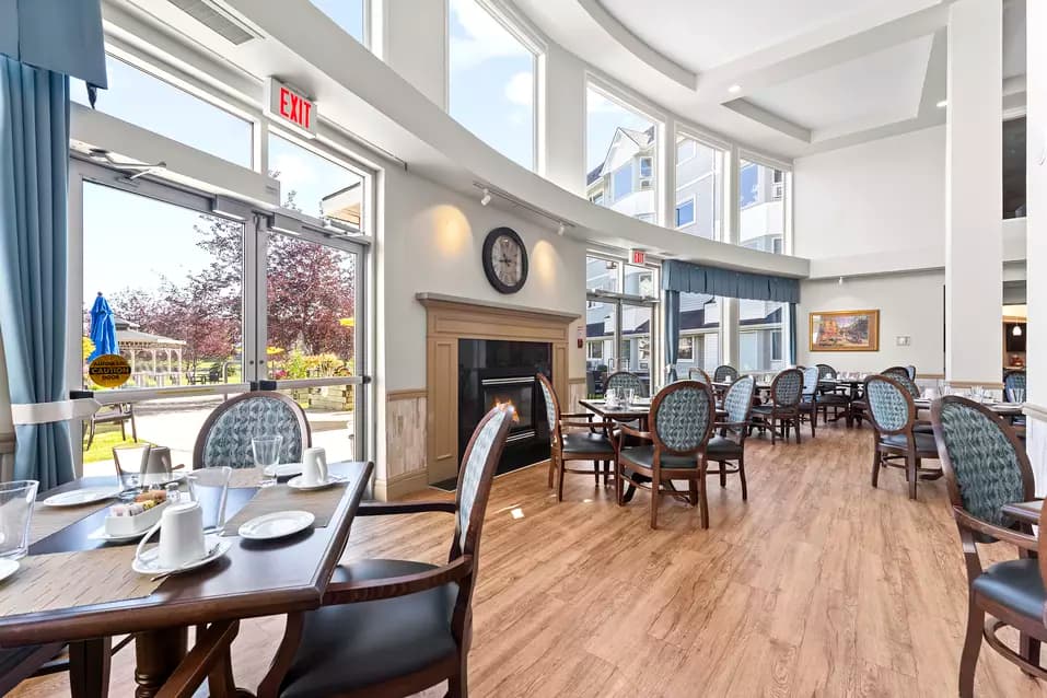 Chartwell Harbours's dining room with a large fireplace and large windows