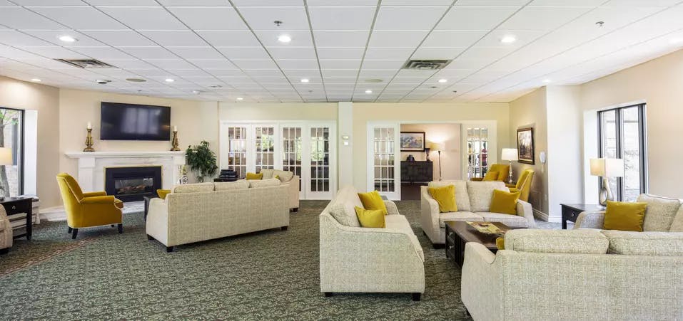 Chartwell Christopher Terrace Retirement Residence lounge with tv and fireplace