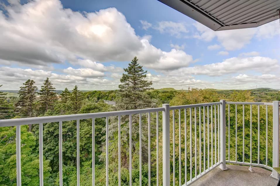 Chartwell Domaine Cascade's balcony view of the wooded area around the residence