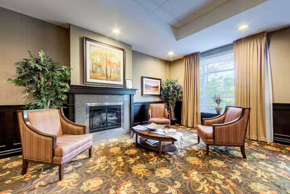 Chartwell Westmount's common area fireplace and comfortable chairs