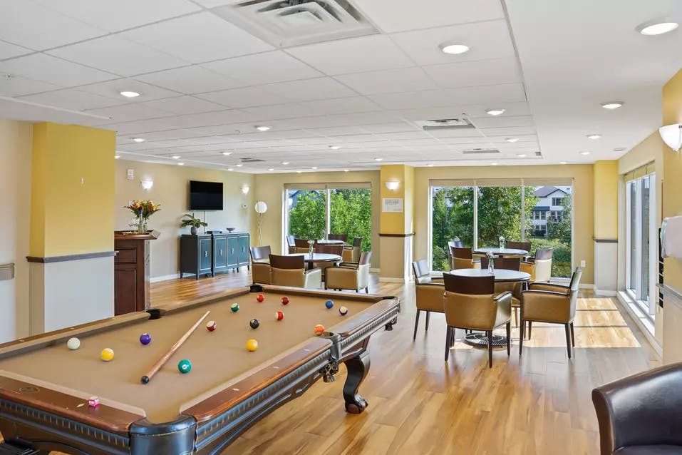 pool table and sitting area at chartwell heritage valley retirement residence