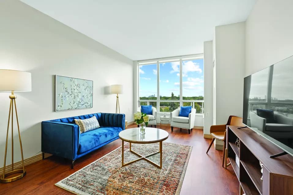 Suite living room with large windows at Chartwell Scarlett Heights Retirement Residence