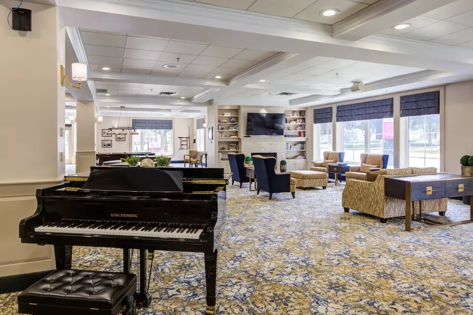 Piano lounge at Chartwell Queen's Square Retirement Residence