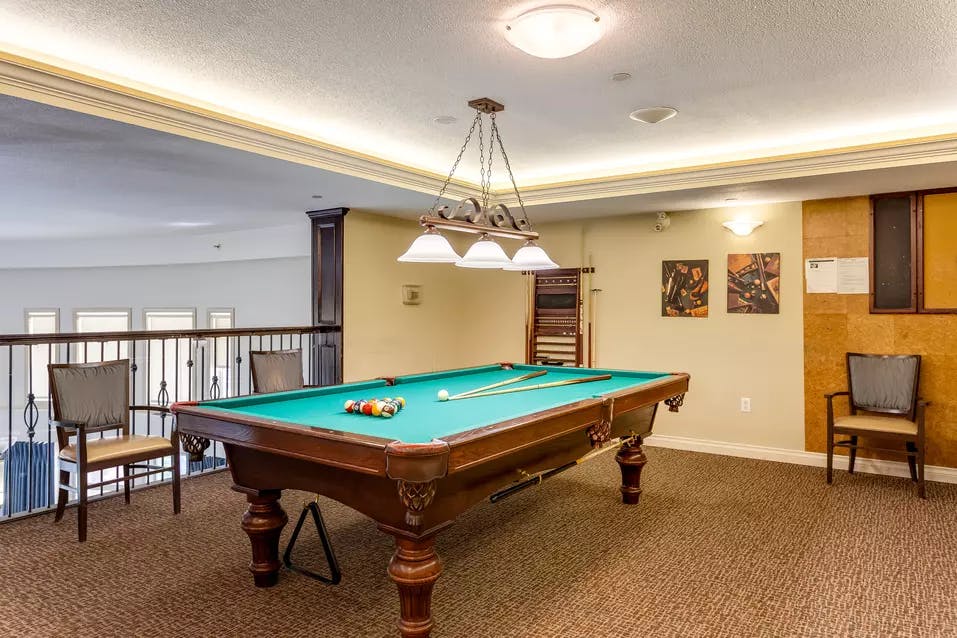 pool table and sitting area at chartwell colonel belcher retirement residence