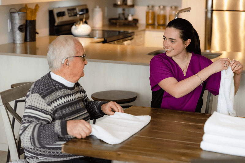 Chartwell Care employee folding laundry