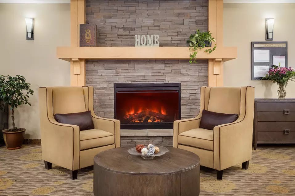 warm and cozy fireside lounge at chartwell cedarbrooke retirement residence