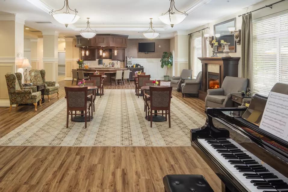 inviting lounge with a piano at chartwell chatsworth retirement residence