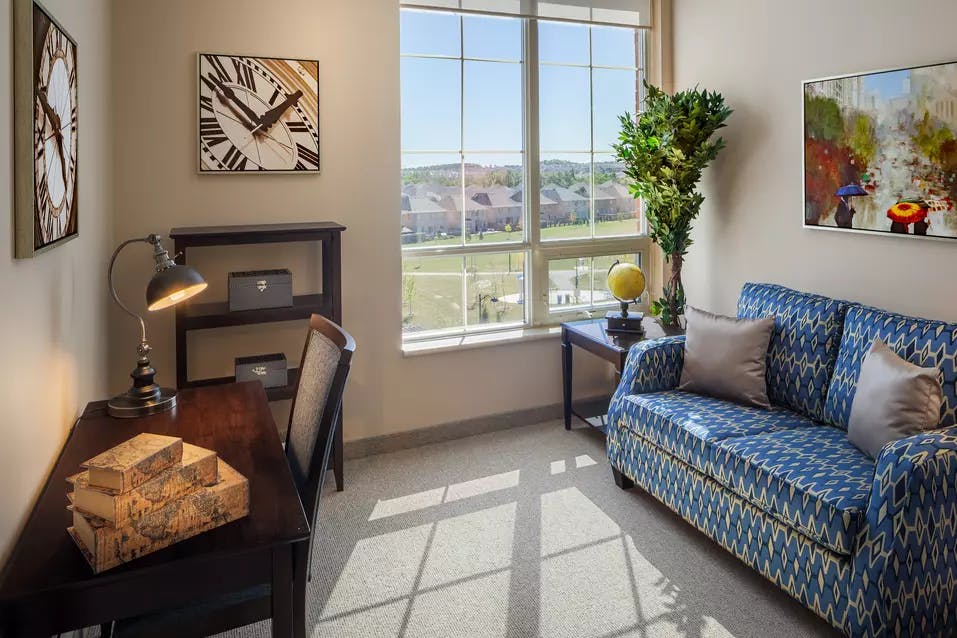 Bright suite living room at Chartwell Valley Vista Retirement Residence 