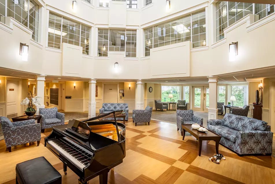 beautiful and bright lounge with piano at chartwell imperial place retirement residence