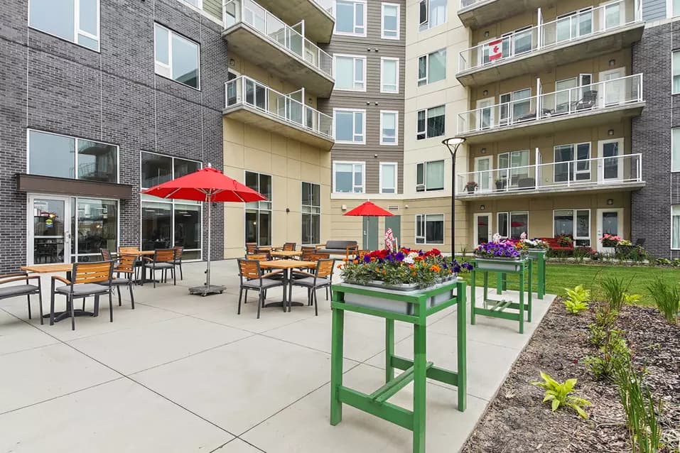 colourful stone courtyard with raised gardens at chartwell emerald hills retirement residence