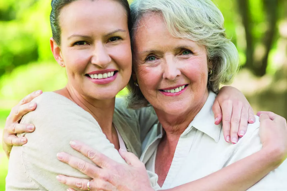 Senior woman and her daughter are hugging each other / Une femme âgée et sa fille se serrent l'une contre l'autre