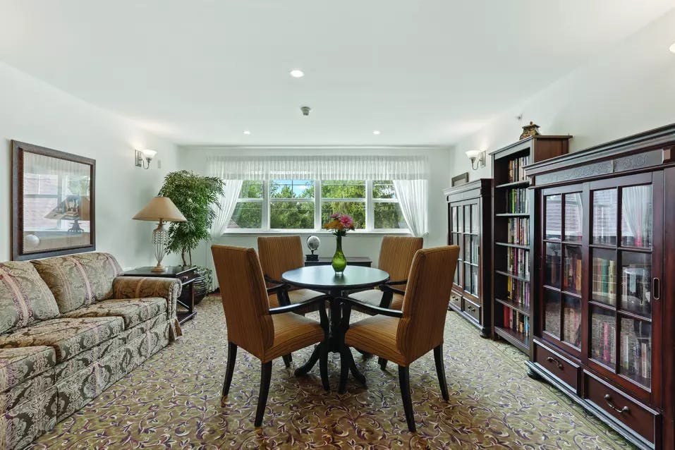 Chartwell Regency Retirement Residence   library with tables and seating