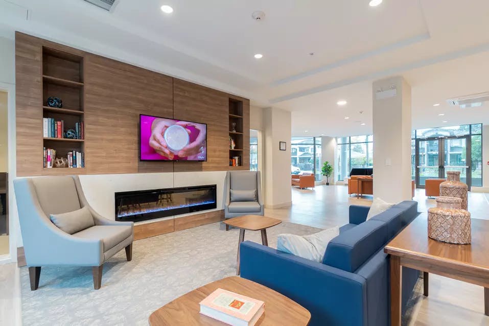 warm and inviting fireside lounge at chartwell camellia retirement residence