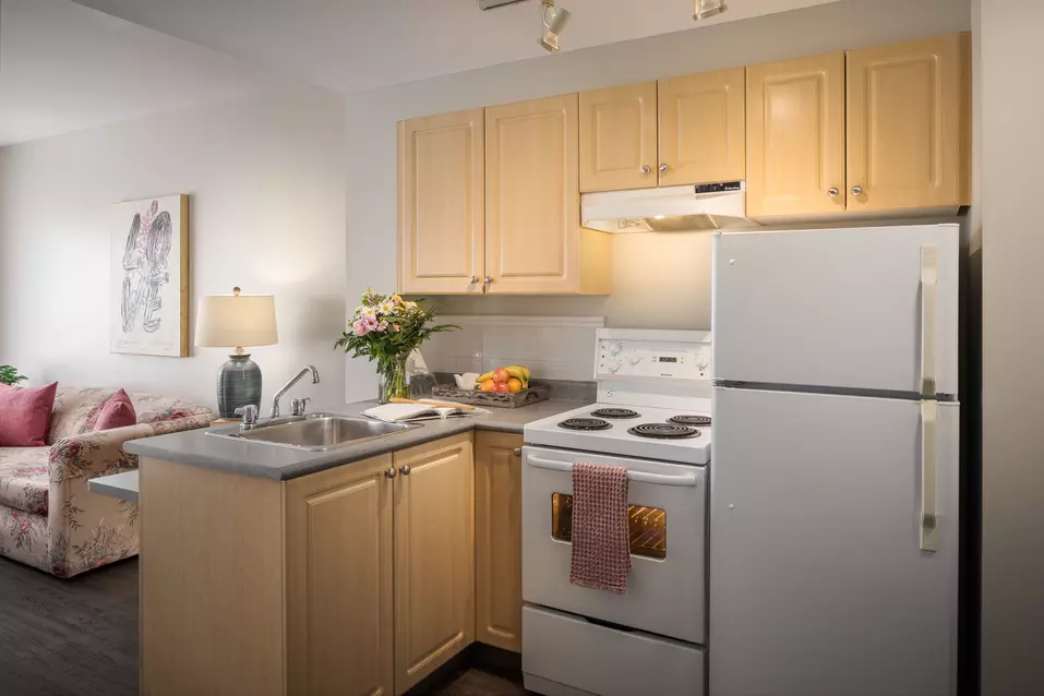 full kitchen with stove and oven at chartwell langley gardens assisted living