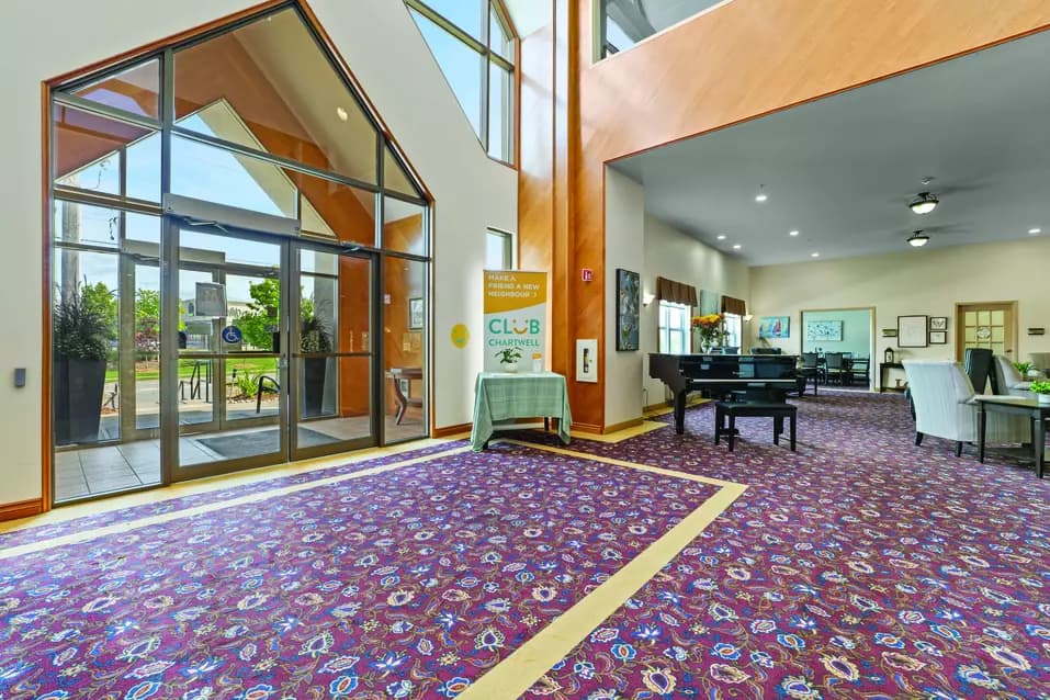 Grand entranceway with floor to ceiling windows at Chartwell Barton Retirement Residence.