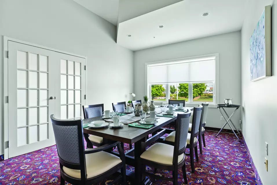 Bright and inviting private dining room at Chartwell Barton Retirement Residence.