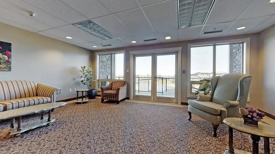 Common space with couch and wing back chairs