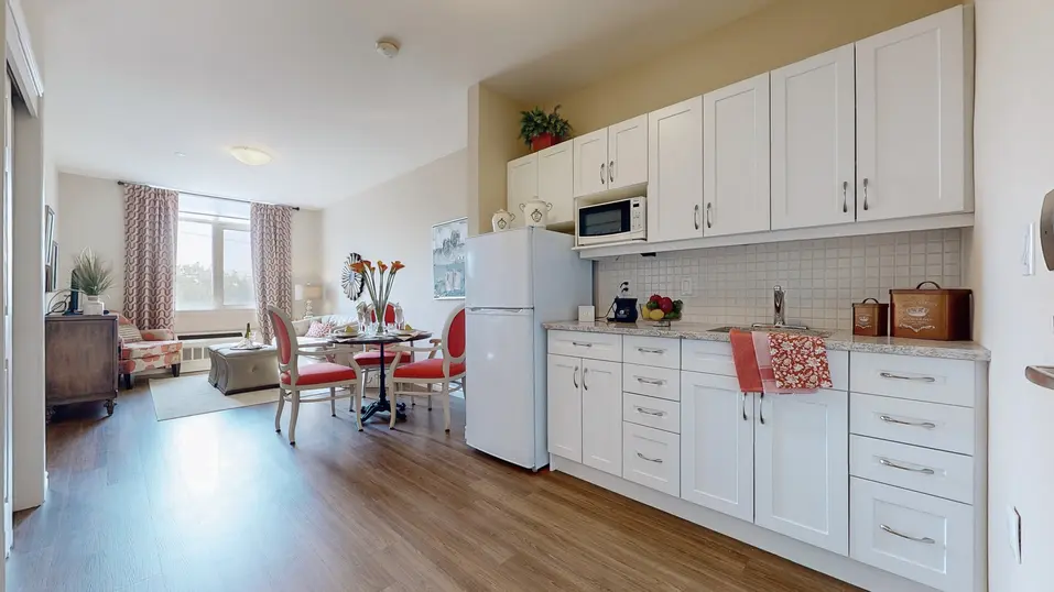Model suite of kitchen and living area at Chartwell Stoney Creeek