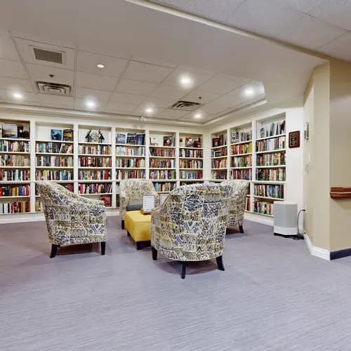Library with book cases and chairs at Chartwell Welland