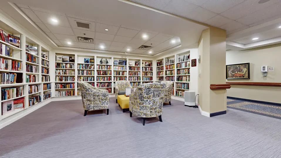Library with book cases and chairs at Chartwell Welland