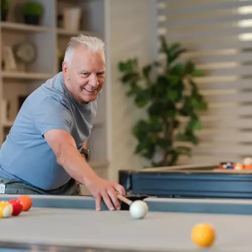 Senior man playing pool