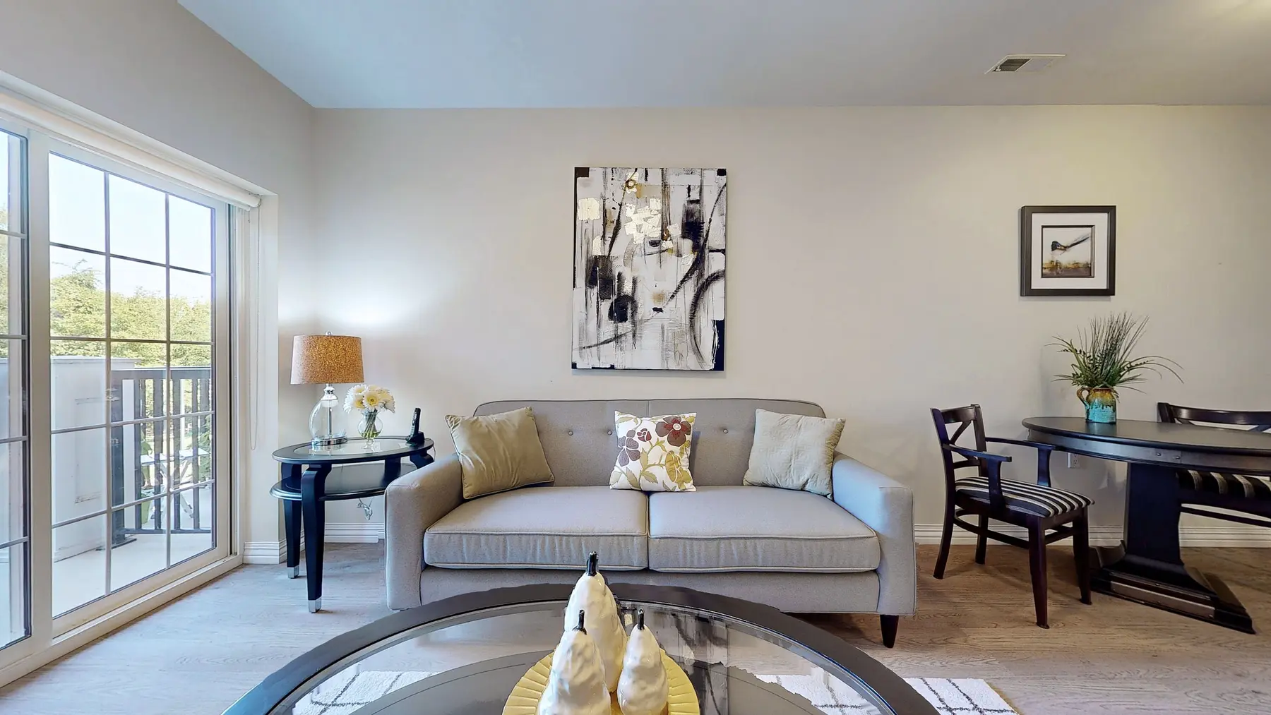 Suite model with a grey couch and table at Chartwell Amherstburg