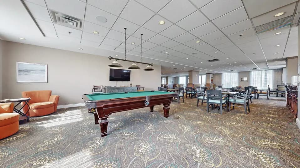 Room with pool table at Chartwell Stoney Creeek